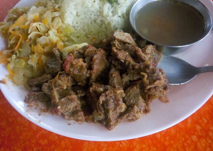 A picture of Vegetable rice with fried beef and steamed cabbage.