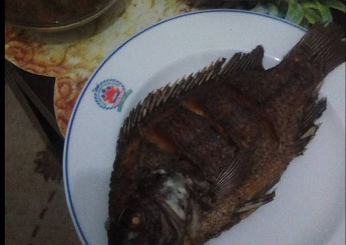 A picture of Fried fish,sukuma and stew.