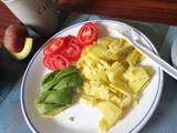 A picture of Boiled sweet potatoes with avocado and tomatoes.