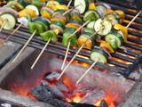 A picture of Grilled veggies and a 1/4 chicken.