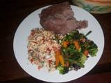 A picture of Brown ugali, fried eggs and mixed vegetables.