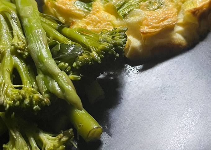 A picture of Spring onion & Cheese baked omelette with buttered vegetables.