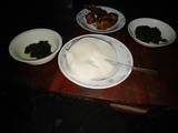 A picture of Ugali sukuma with fried fish.