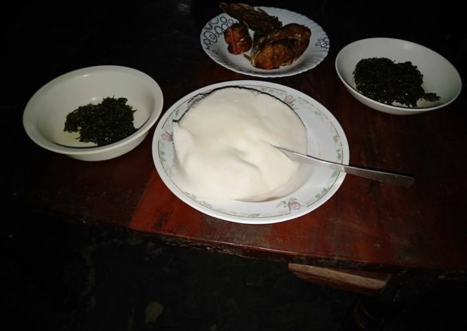 A picture of Ugali sukuma with fried fish.