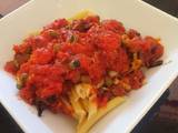 A picture of Pasta in spicy chorizo tomato sauce with capers.