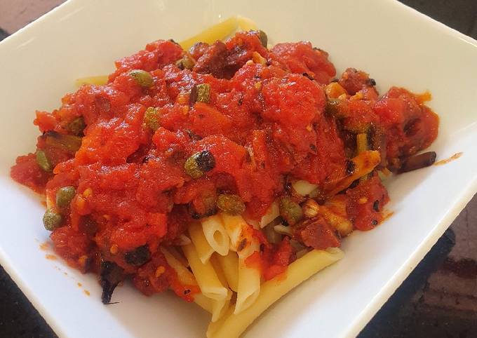 A picture of Pasta in spicy chorizo tomato sauce with capers.