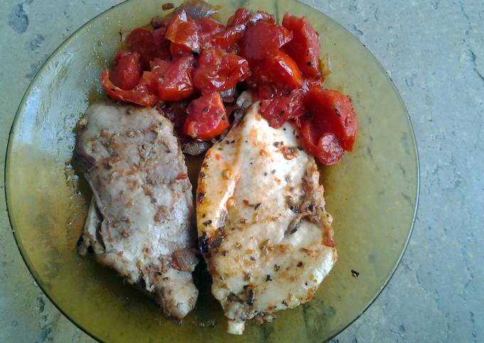 A picture of Chicken breasts with thyme and vegetables.