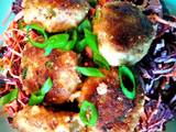 A picture of Thai-inspired pork meatballs with sesame-soy shredded vegetables.