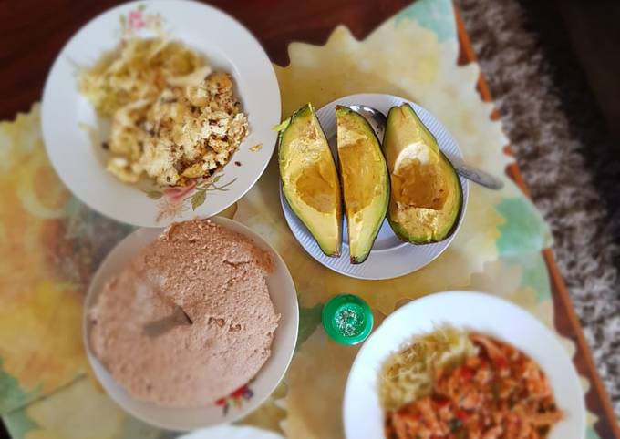 A picture of Dry and wet eggs with cabbages,avocadoes and ugali.