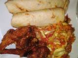 A picture of Flat bread, fried chicken with side vegetable sauce.