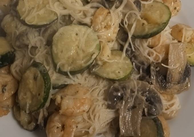 A picture of Vermicelli rice noodles with mushrooms, courgettes and prawns.