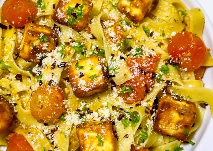 A picture of Fettuccine Aglio e Olio with Cherry Tomatoes and Halloumi Cubes.