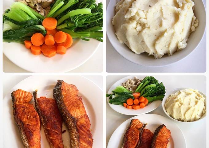 A picture of Salmon with mash potato and vegetables.