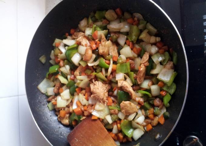 A picture of shrimps chicken breast vegetables sauce.