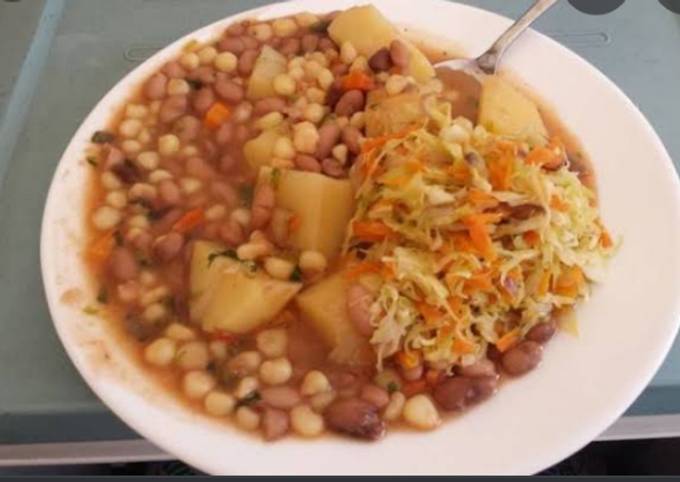 A picture of Githeri mixed with cabbage carrot and potatoes.