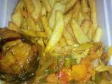 A picture of Chips with vegetable sauce and fish.