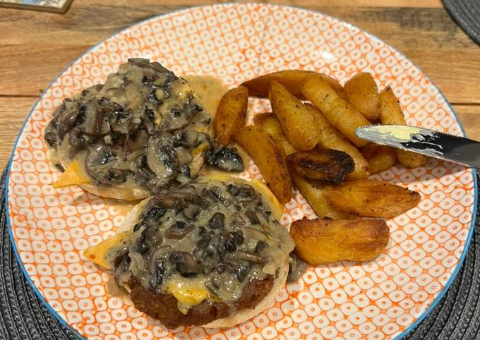 A picture of Open Burgers with mushroom sauce & fries.