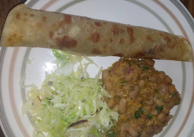 A picture of Chapati served with yellow beans and steamed cabbages.