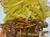 A picture of Plain french fries and smokies with mixed veggies.