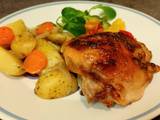 A picture of Chicken thighs in "onion" mayonnaise with vegetables, in the oven.