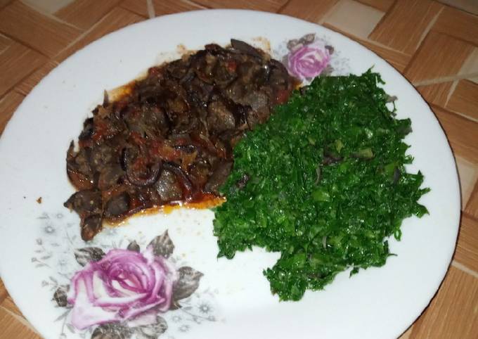 A picture of Green vegetables and wet fry liver.