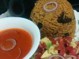 A picture of Pilau with spicy tomato soup.