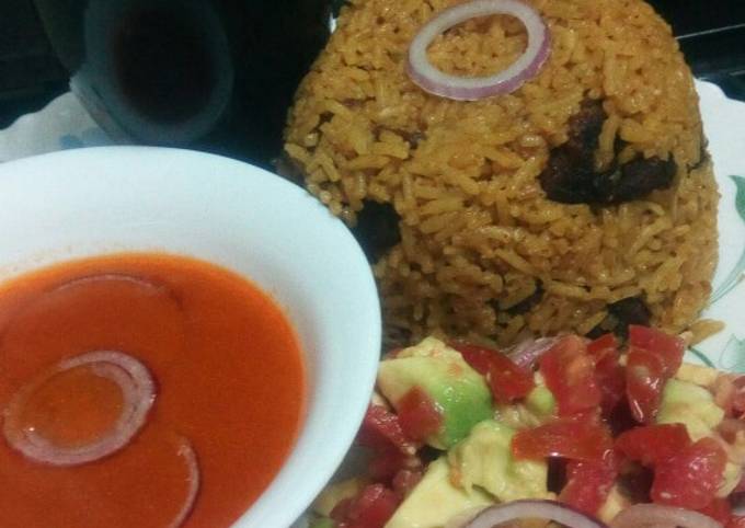 A picture of Pilau with spicy tomato soup.