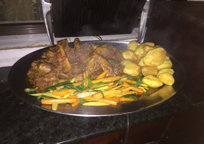 A picture of Kienyeji chicken,roasted potatoes and veggies.