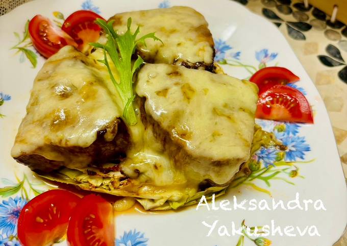 A picture of Tuna (fillet), baked on cabbage steaks, with cheese.