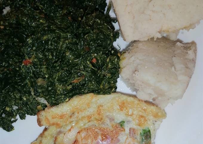 A picture of Ugali, kunde cooked in cream with scrambled vegetable eggs.