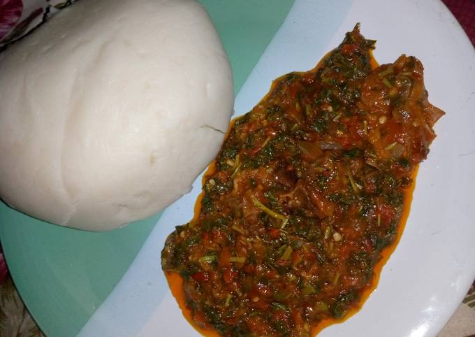 A picture of Pounded yam and vegetable soup.