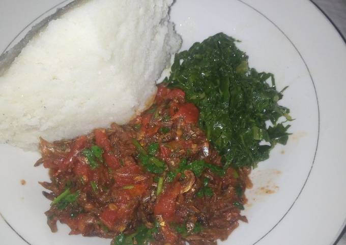 A picture of Fried Omena Sukuma wiki and ugali.