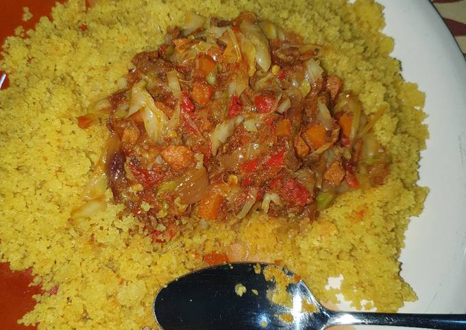 A picture of Fried cous cous with vegetable and shredded beef stew.