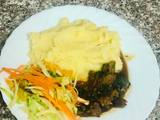 A picture of Creamy Mash Potato with Beef stew and Fresh vegetables.