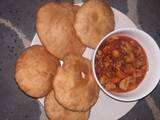 A picture of Poori paratha with potato and vegetables sauce.