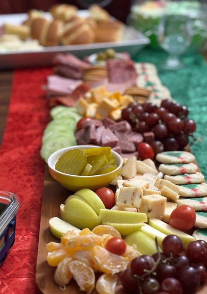 A picture of Christmas charcuterie board/mini sandwiches.