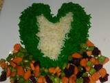 A picture of Green and white rice with vegetable sauce.