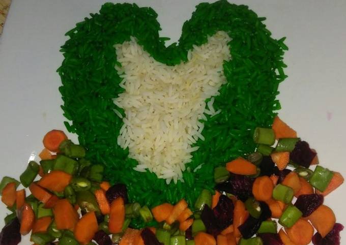 A picture of Green and white rice with vegetable sauce.