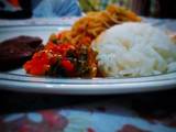 A picture of White rice and spaghetti with fried beef and vegetable sauce.