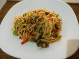 A picture of Fried noodle with egg and vegetables.