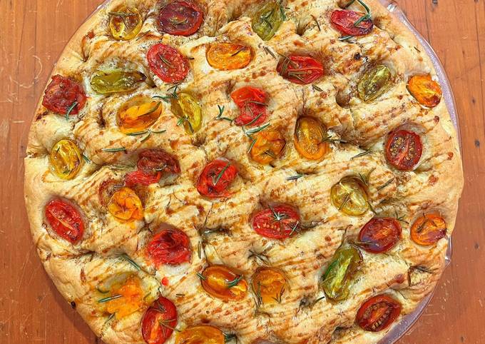 A picture of Foccacia with cherry tomatoes, rosemary and pomegranate molasses.