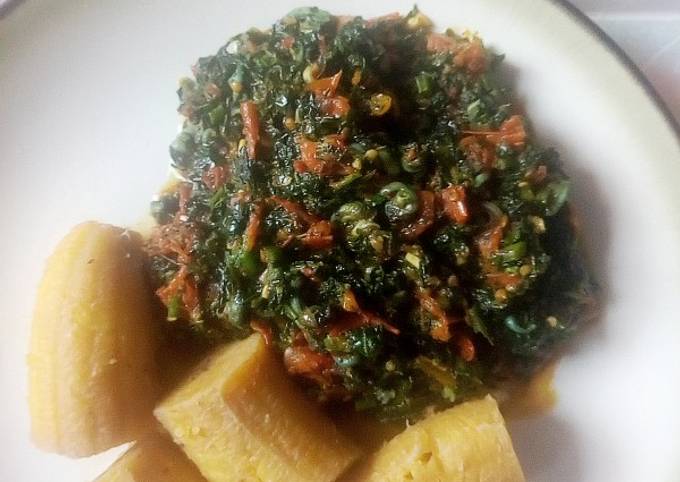 A picture of Boiled unripe plantain with veg sauce.