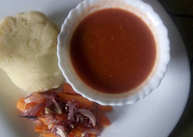 A picture of Oven baked carrot strips with smooth mashed potatoes and homemade garlic tomato sauce.