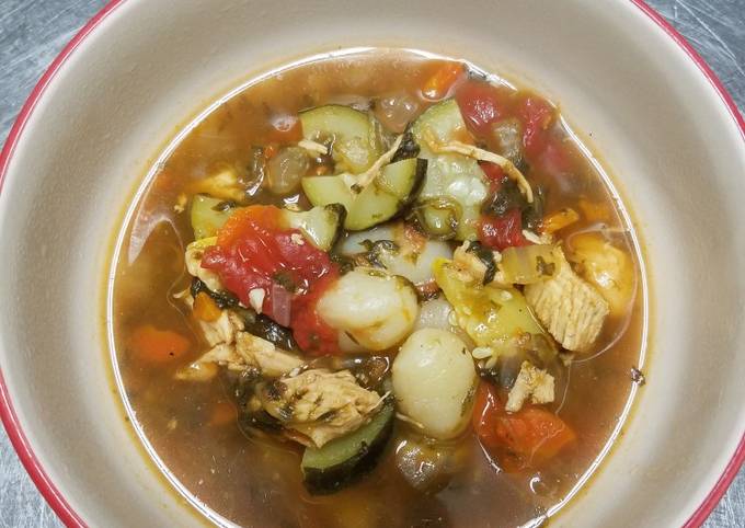 A picture of Chicken vegetable soup with gnocchi.