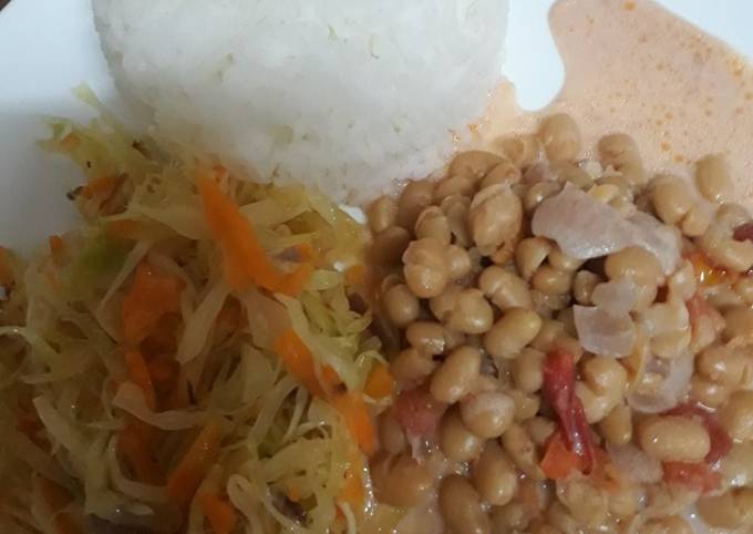 A picture of Rice, steamed cabbage and coconut beans.