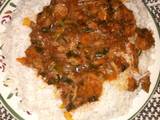 A picture of White rice wth vegetable soup.