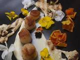 A picture of Seared scallops with cauliflower puree, chargrilled cauliflower and edible flowers.