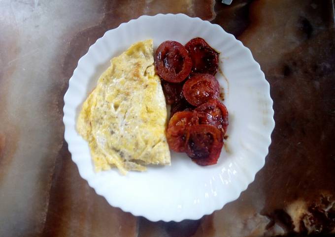 A picture of Fried tomatoes with eggs.