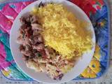 A picture of Tumeric rice with cabbage and pork.