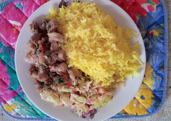 A picture of Tumeric rice with cabbage and pork.